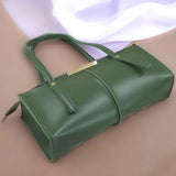 Green handbag on a beige background