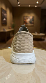 Minimalist beige sock-style sneaker featuring textured knit upper and white platform sole