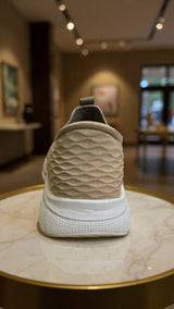 Minimalist beige sock-style sneaker featuring textured knit upper and white platform sole