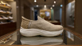 Minimalist beige sock-style sneaker featuring textured knit upper and white platform sole