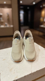 Light beige comfort slip-on shoe featuring soft fabric and flexible outsole