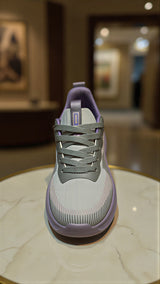Lightweight cushioned running shoes available in purple-grey and light green.