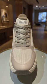 Light beige athletic sneaker with thick sole and breathable mesh design