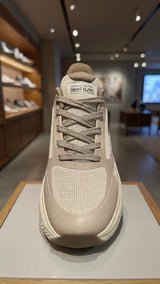 Light beige athletic sneaker with thick sole and breathable mesh design