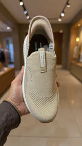 Beige slip-on knit walking shoe with breathable upper and cushioned sole