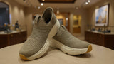 Comfort-focused gray slip-on walking shoes featuring textured knit upper and chunky sole