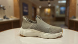 Comfort-focused gray slip-on walking shoes featuring textured knit upper and chunky sole