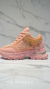 Back side of white and pink kids sneakers